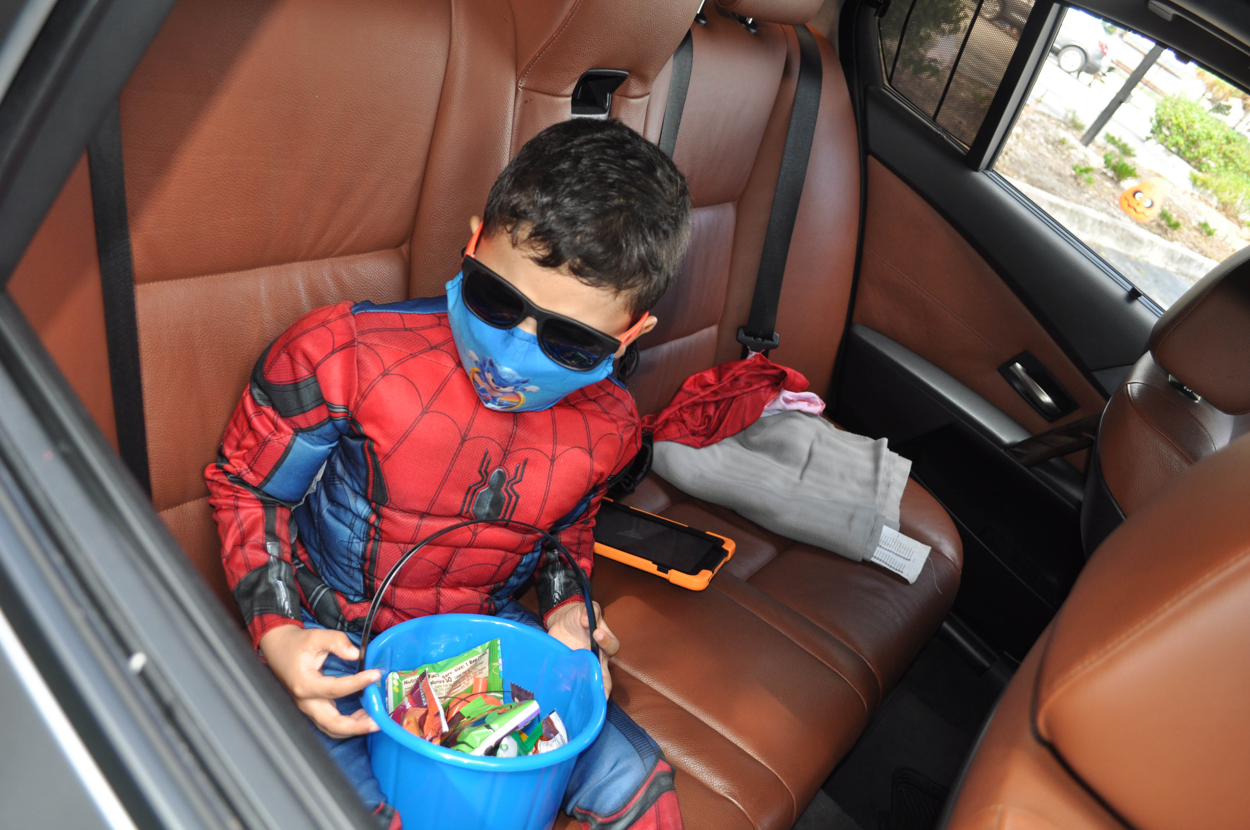 Lighthouse of Broward client Matthew Caraballo dressed as Spiderman shows off his candy