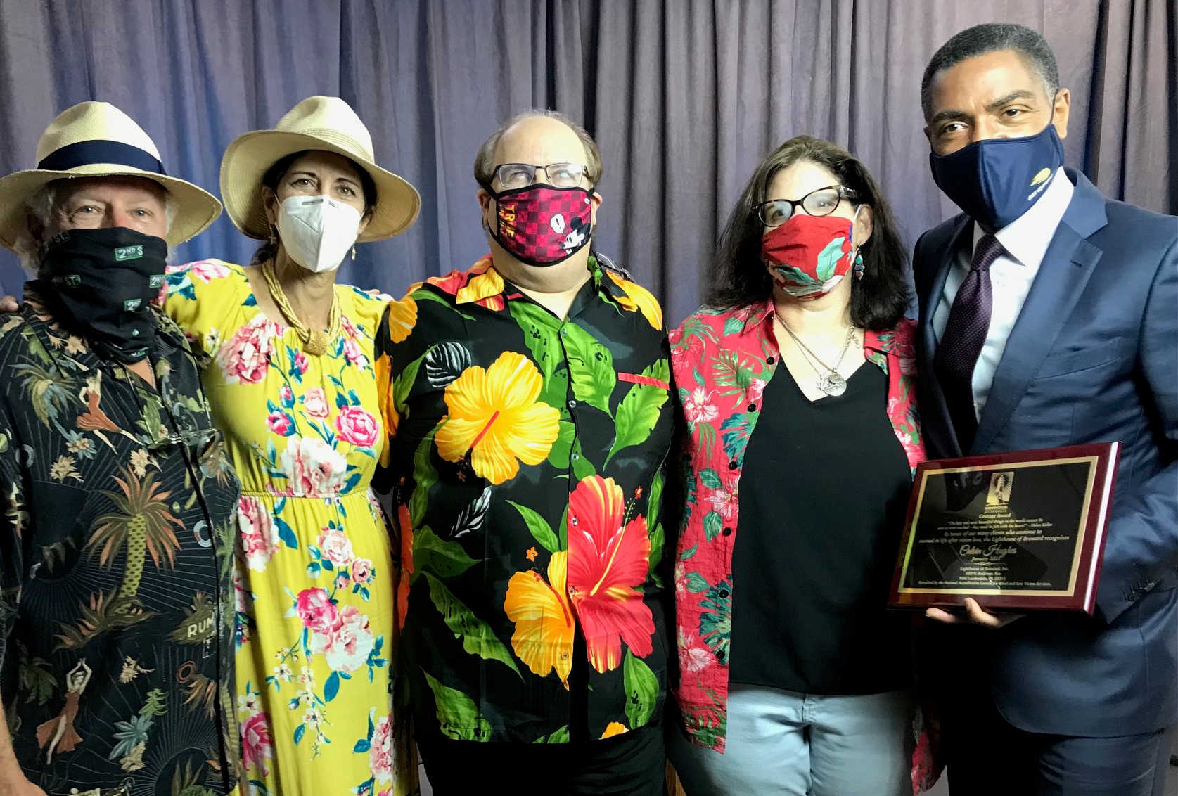 Stu Stewart, Marianne Finizio, Jose Lopez Masso and Ellyn Drotzer present a thank-you plaque to WPLG Local 10 Anchor Calvin Hughes, who emceed the event